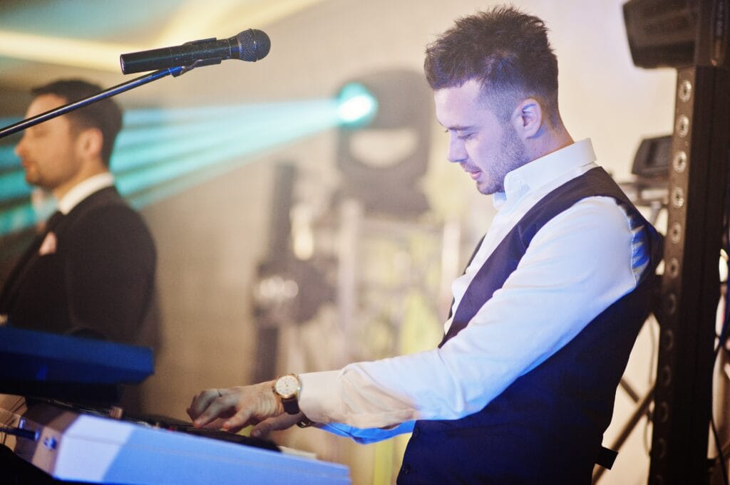 someone is playing music at an event implementing Marketing Strategies for Restaurants Host Events and Promotions to Create Buzz