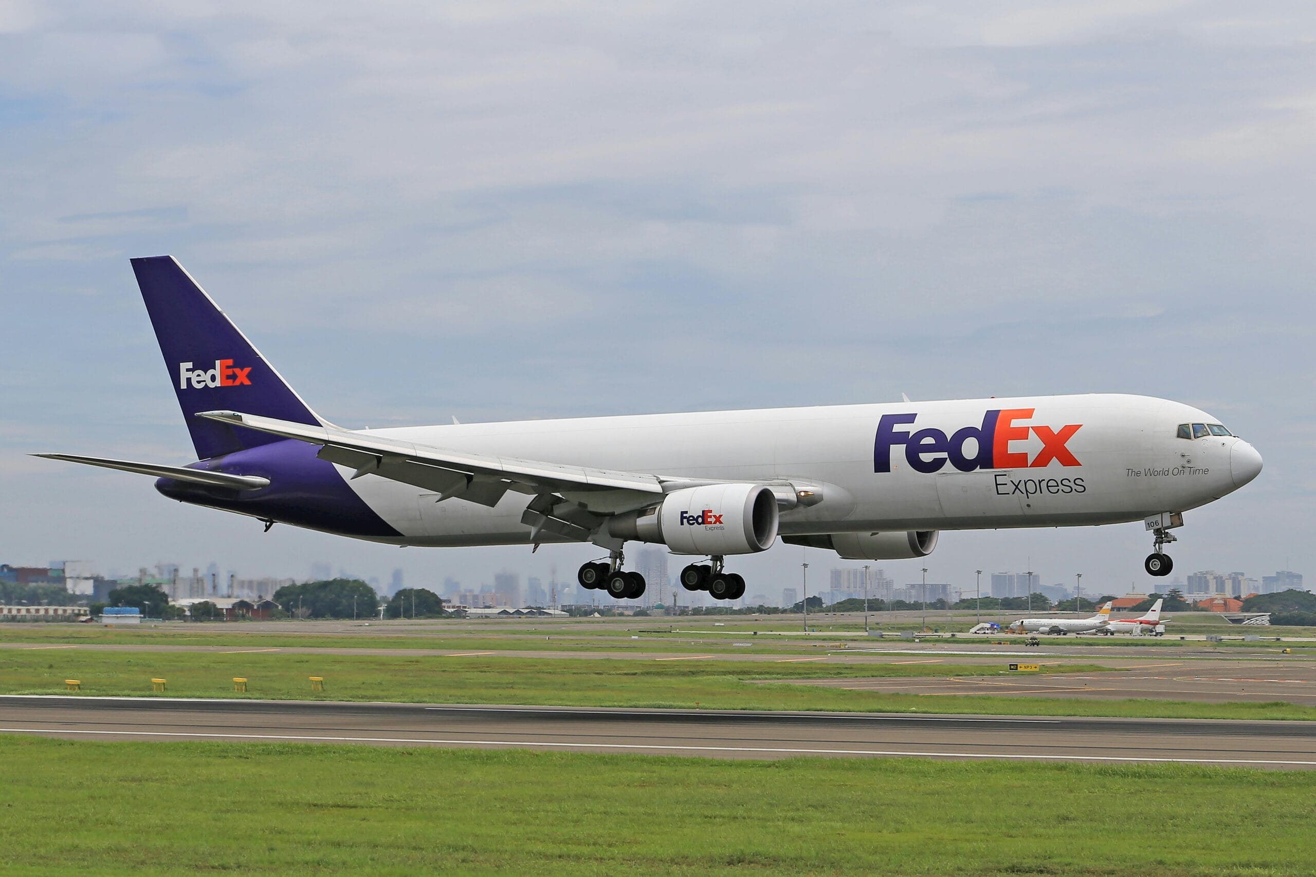 FedEx cargo airplane flying midair, symbolizing consistent branding for small business growth